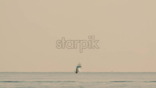 Video - A navigation buoy in the foreground and a yacht on the horizon in the Mediterranean Sea near France