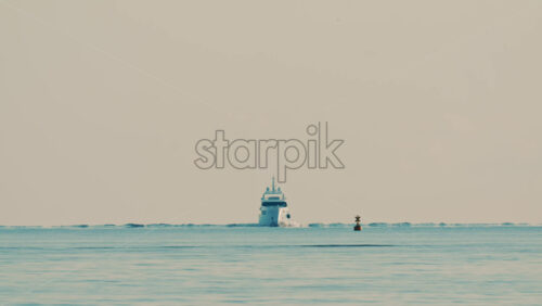 Video - A navigation buoy in the foreground and a yacht on the horizon in the Mediterranean Sea near France