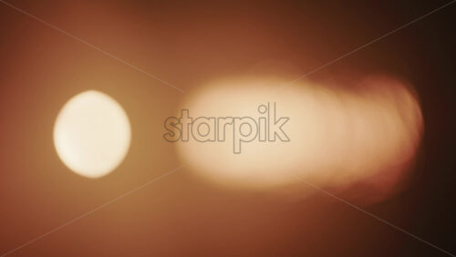Video - Abstract, out of focus shot of the sun and its reflection on the sea. Vertical