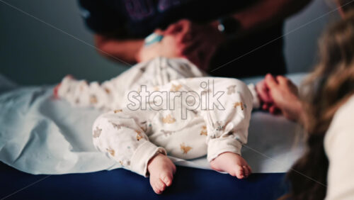 Video - Baby gently cradled by a caregiver during a pediatric session
