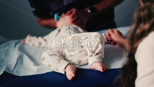 Video - Baby gently cradled by a caregiver during a pediatric session