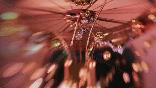 Video - Abstract shot of warm toned Christmas lights and hanging ornaments, blurred creating a festive bokeh effect