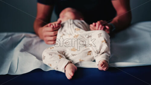 Video - Baby gently cradled by a caregiver during a pediatric session