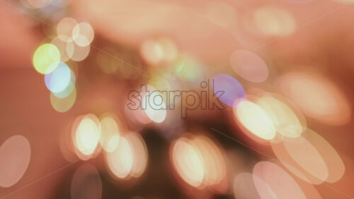 Video - Abstract composition of warm holiday lights creating a glowing bokeh pattern, with no distinct objects in focus