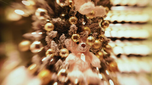 Video - A softly lit Christmas tree decorated with gold baubles and warm fairy lights