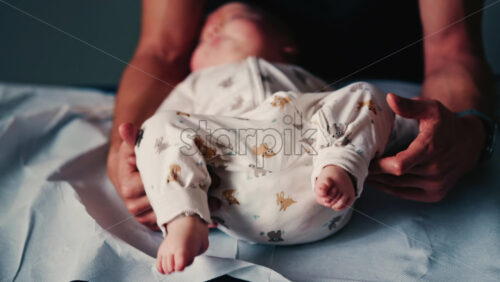 Video - Baby gently cradled by a caregiver during a pediatric session