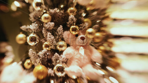 Video - A softly lit Christmas tree decorated with gold baubles and warm fairy lights