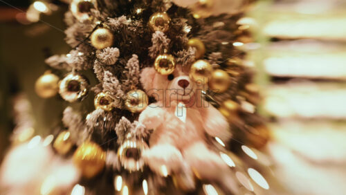 Video - A softly lit Christmas tree decorated with gold baubles and warm fairy lights