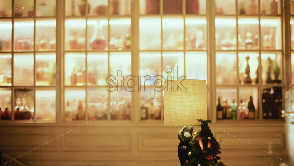 Video - A warmly lit interior featuring large window like shelves filled with bottles