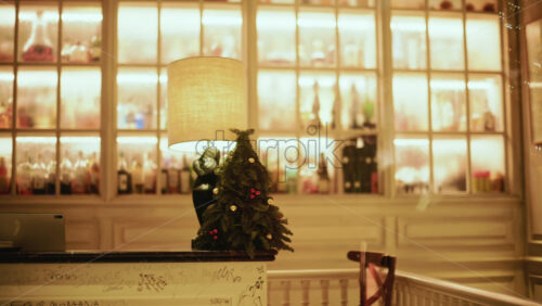 Video - Room showing framed artwork on the wall, soft glowing particles or reflections, and warm ambient lighting