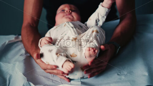 Video - Baby gently cradled by a caregiver during a pediatric session