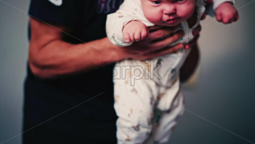 Video - Infant practicing tummy time on a padded surface while a caregiver gently supports the baby's back
