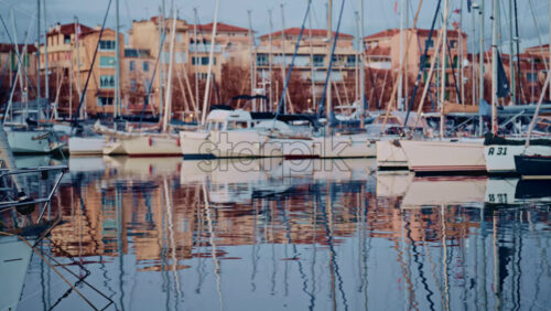 Video - Boats lined up along a waterfront with colorful residential buildings behind them