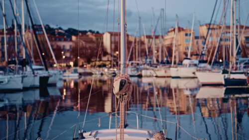 Video - Centered perspective from the bow of a sailboat docked in a Mediterranean marina, likely in southern France