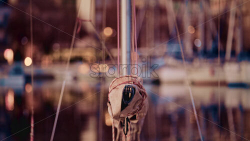 Video - Centered perspective from the bow of a sailboat docked in a Mediterranean marina, likely in southern France