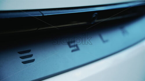 Video - Cannes, France - December 23, 2025: Close up of the Tesla logo on the rear of a white electric vehicle, with clean lines and modern automotive design