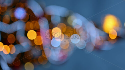 Video - Out of focus Christmas light decorations on a Christmas tree outside. Vertical