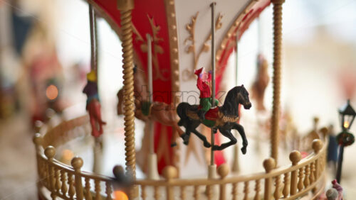 Video - Close up of a miniature vintage carousel with decorative horses and ornate details