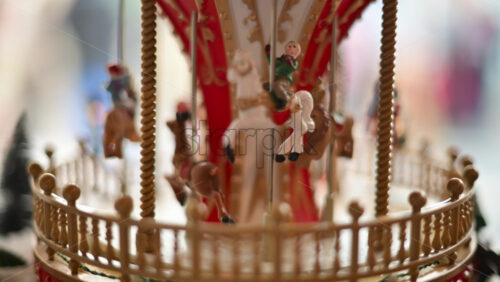Video - Close up of a miniature vintage carousel with decorative horses and ornate details