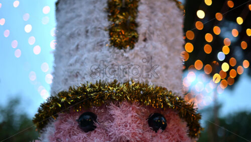 Video - Close up of a decorative Christmas nutcracker soldier figure displayed outdoors with trees in the background