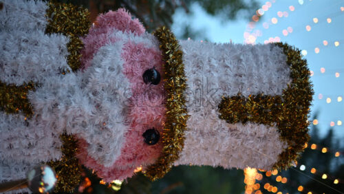 Video - Decorative Christmas nutcracker soldier figure displayed outdoors with trees in the background. Vertical