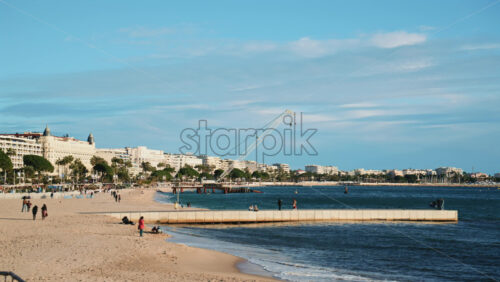 Video - Wide view of the sandy beach and calm Mediterranean Sea along Cannes' coastline