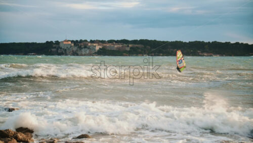 Video - Windsurfer riding waves on the Mediterranean Sea with ile Sainte Marguerite in the background