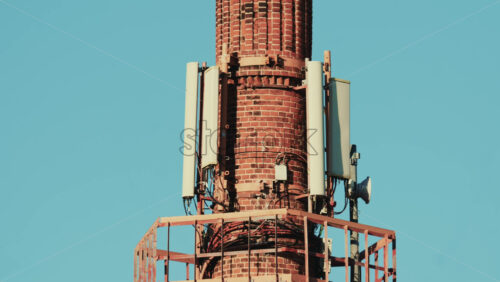 Video - Close up view of multiple telecommunications antennas mounted on a tall brick chimney