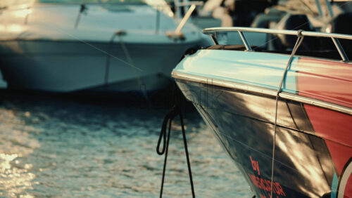 Video - Vallauris, France - December 27, 2025: Close up of the bow of a motorboat tied with ropes at a marina