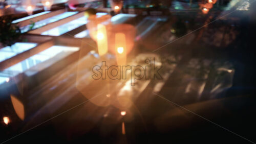 Video - Abstract view of warm candlelight reflected on a camera lens