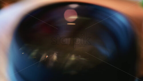 Video - Close up of a camera lens showing curved glass elements and internal reflections