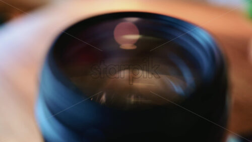 Video - Close up of a camera lens showing curved glass elements and internal reflections