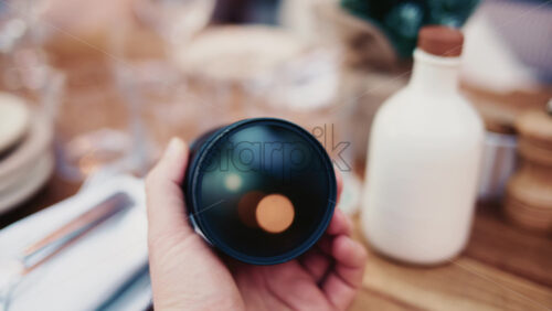 Video - Close up of camera lens with warm bokeh light reflections inside the glass
