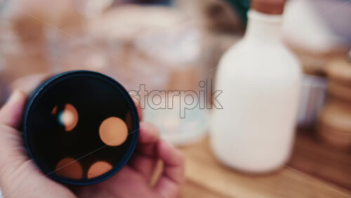 Video - Close up of camera lens with warm bokeh light reflections inside the glass