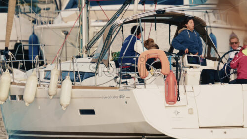 Video – Antibes, France – December 17, 2025: Group of people seated on a sailboat while maneuvering in a marina - Starpik Stock