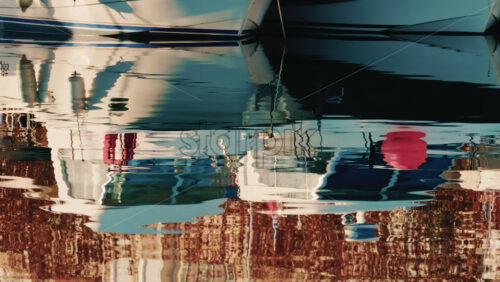 Video – Antibes, France – December 22, 2025: Close up of docked boats reflected on still marina water on the French Riviera - Starpik Stock