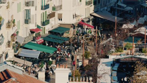 Video – Cannes, France – December 20, 2025: Elevated view of lively outdoor cafes and restaurants along a pedestrian street - Starpik Stock