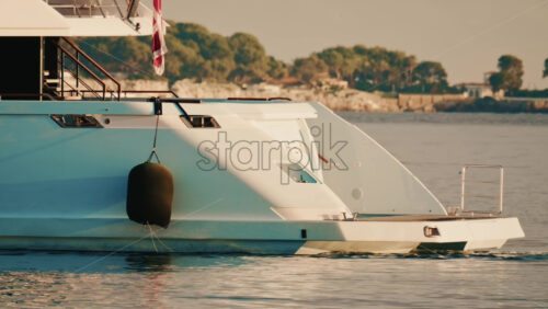 Video – Cannes, France – December 22, 2025: Detailed close up of a luxury yacht hull with a hanging black fender and waterline visible - Starpik Stock