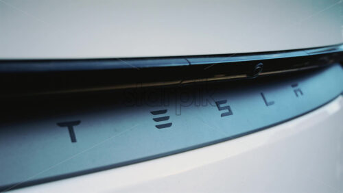 Video – Cannes, France – December 23, 2025: Close up of the Tesla logo on the rear of a white electric vehicle, with clean lines and modern automotive design - Starpik Stock