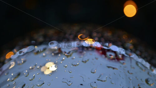 Video – Close up of raindrops on a bauble with colorful lights - Starpik Stock