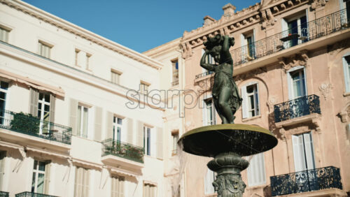 Video – Close up view of a bronze fountain statue with flowing water, surrounded by classic architecture in the Place du General de Gaulle - Starpik Stock