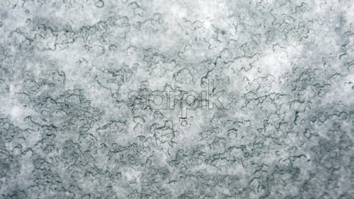 Video – Close up view of an icy or frosted surface with fine texture and soft blue tones - Starpik Stock
