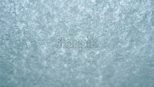 Video – Close up view of an icy or frosted surface with fine texture and soft blue tones - Starpik Stock