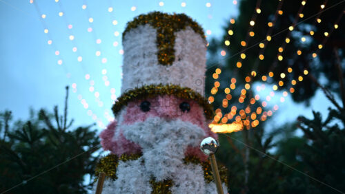 Video – Decorative Christmas nutcracker soldier figure displayed outdoors with trees in the background - Starpik Stock