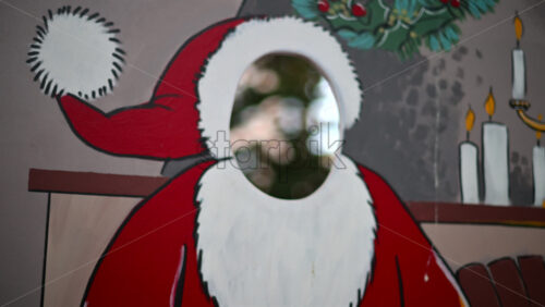 Video – Festive Christmas stand-in board featuring Santa Claus with face cut out - Starpik Stock