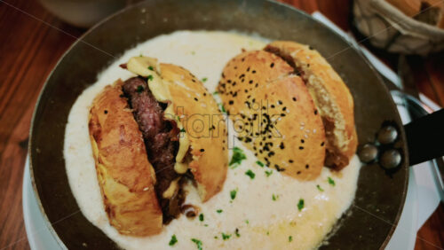 Video – French burger in a special goat milk sauce on a pan - Starpik Stock