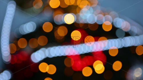 Video – Out of focus Christmas light decorations forming warm yellow, red, and white bokeh shapes - Starpik Stock