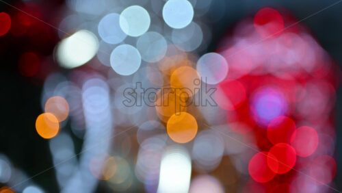 Video – Out of focus Christmas light decorations forming warm yellow, red, and white bokeh shapes - Starpik Stock