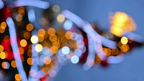 Video – Out of focus Christmas light decorations on a Christmas tree outside. Vertical - Starpik Stock