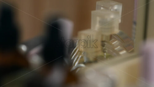 Blurred close up of perfume bottles arranged on a dressing table